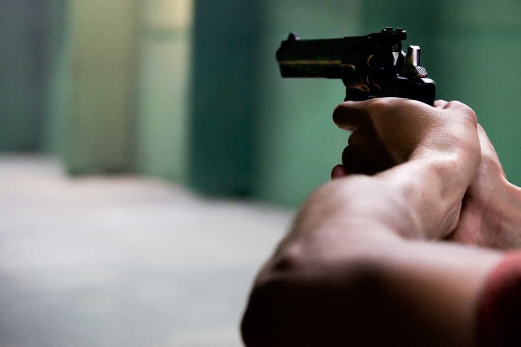 Woman firing a revolver