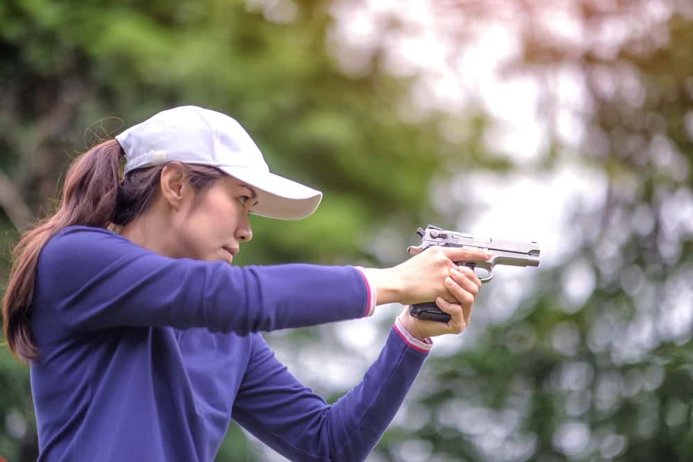 Woman holding gun in weaver stance