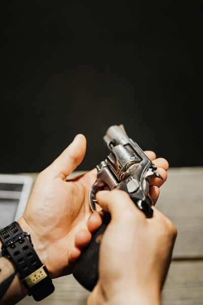 person holding revolver