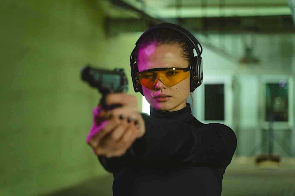 Woman at indoor shooting range using beb ammo